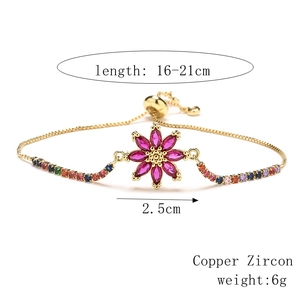 Detailed view of adjustable gold flower bracelet with pink zircon and multi-color stones