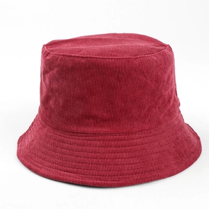Macro view of a classic burgundy solid color corduroy bucket hat with soft ribbed texture