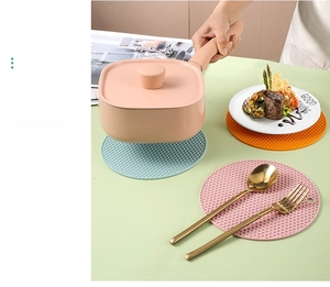 Detail of round honeycomb silicone heat resistant mats with hanging hole in various colors