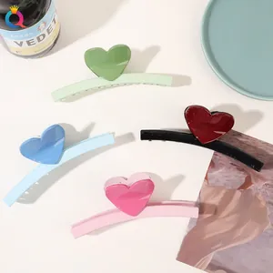 Set of colorful heart-shaped claw clips in green, blue, pink and black glossy resin