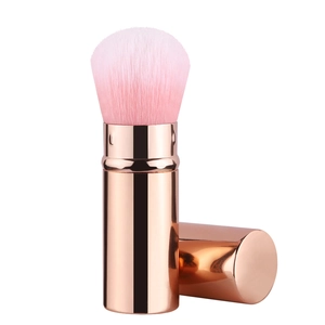 Detail of rose gold retractable makeup brush with pink gradient synthetic bristles