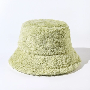 Close-up of mint green plush bucket hat showing soft faux fur texture and thick material