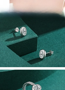 Detailed view of S925 sterling silver oval stud earrings with bezel-set cubic zirconia