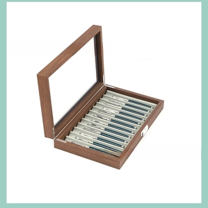 Detail view of the 12-slot wooden pen display box with clear glass lid and velvet lining
