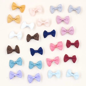 Detailed overhead view of 24 colorful grosgrain ribbon bow clips in various pastel shades