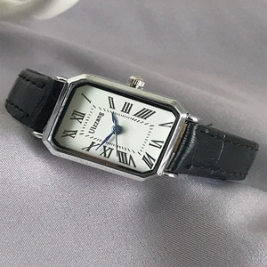Elegant rectangular women's watch with blue hands, roman numerals and black leather strap
