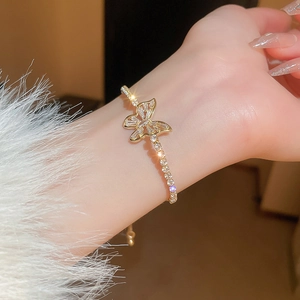 Close-up of golden butterfly bracelet with cubic zirconia on a model wrist