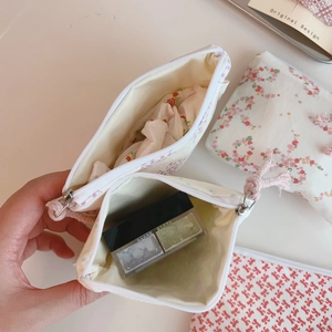 Detail view of cotton floral pouch interior storage for cosmetics and accessories