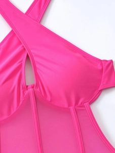 Hot pink one-piece swimsuit detail showing sexy cutout neckline and mesh patchwork fabric