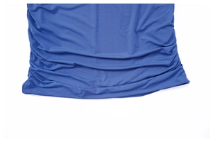 Detail view of the royal blue pleated fabric texture and ruched hem design on a mini skirt