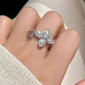 Elegant French-style silver floral ring with zircon stones shown on a female hand