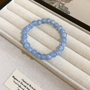 Elegant light blue ice-cracked crystal bead bracelet displayed in a luxury jewelry box