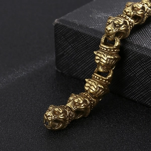 Macro shot of vintage gold tiger head link bracelet with intricate engraved metal textures