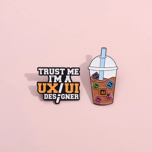 UX/UI designer quote and Adobe software icons enamel pins on pink background