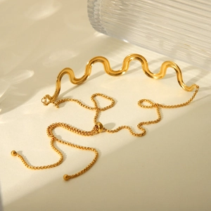 Detail showing an adjustable 18K gold stainless steel wave necklace with a slide clasp