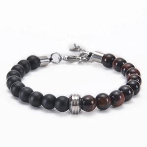 Macro detail of 8mm matte black stone and tiger eye beads with steel spacers