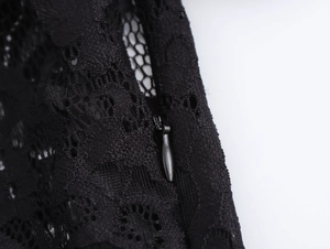 Close-up detail of exquisite black lace pattern and durable hidden metal zipper on dress