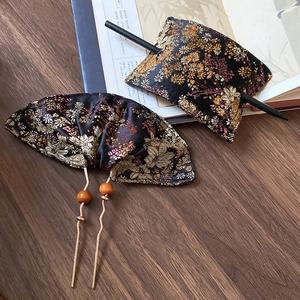 Detailed close-up of handmade embroidered floral hairpins with traditional Chinese patterns