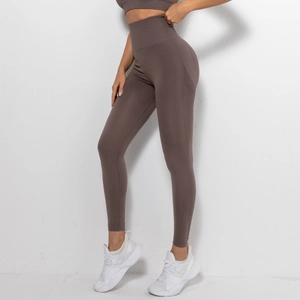 Detail of dark brown seamless high waist yoga pants showing tummy control and mesh texture