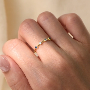 Delicate sterling silver gold ring featuring a gradient of blue zircon stones for women