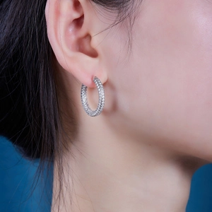 Sparkling S925 sterling silver hoop earrings with pavé moissanite stones on a model