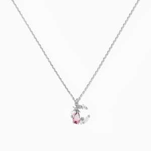 Detail of star and moon necklace with purple water drop gemstone and pearl