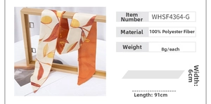 Detail of 91x6cm polyester twilly scarf with autumn leaf pattern and gold lettering