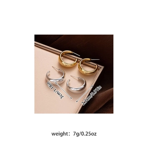 Polished 3cm gold and silver C-shaped hoop earrings on elegant silk background