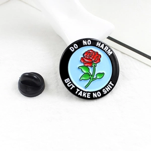 Enamel flower pin with 'DO NO HARM BUT TAKE NO SHIT' text on white textured background