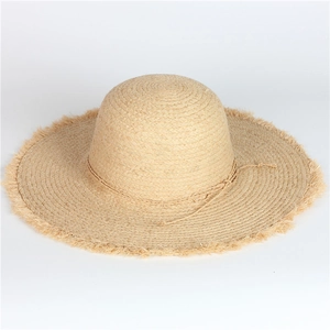 Handmade wide brim raffia sun hat for women with elegant frayed edges and bow detail