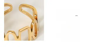 Detail of 18K gold plated titanium steel ring with hollow geometric patchwork design