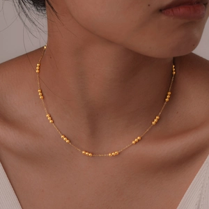 Minimalist gold beaded choker necklace for women with small polished steel balls