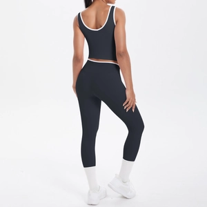 Detail of cross-back yoga top and high-waisted leggings with white contrast piping