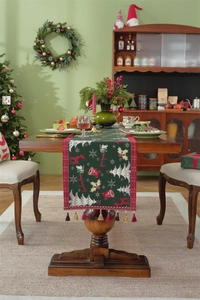Close-up of green Christmas table runner featuring jacquard reindeer and snowflake patterns