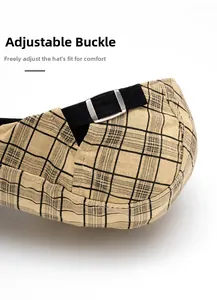 Detail of adjustable metal buckle on plaid cotton newsboy hat for custom sizing