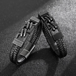 Detail of woven leather bracelets with vintage silver and matte black metal clasps