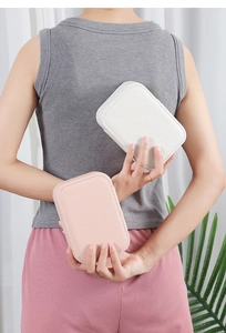Portable PU leather jewelry organizer in white and pink held by hand for scale