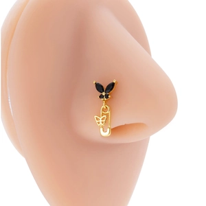 Gold butterfly nose stud with black gemstone and safety pin charm on silicone model