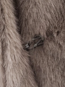 Detailed macro view of soft brown faux fur texture and hidden hook fastener