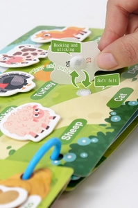 Detail of children soft felt busy book showing hook and loop stickers with animal patterns