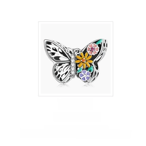 Macro shot of S925 sterling silver hollow butterfly charm with colorful enamel flowers