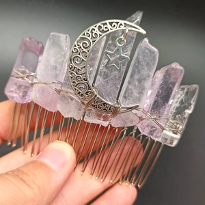 Detailed shot of handmade hair comb with raw crystal quartz and metal moon star pendants