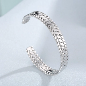 Modern 9mm stainless steel open cuff bangle with wheat pattern engraving on blue background