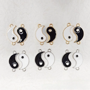 Detailed view of Yin Yang Tai Chi enamel charms with dual hanging loops for DIY jewelry