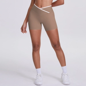Detail of high waist cross-over V-shape yoga shorts with white contrast piping trim