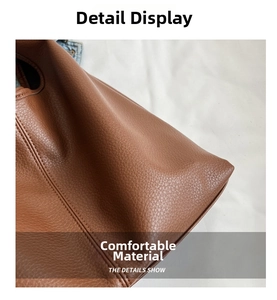 Detailed macro view of the brown lychee pattern leather and neat double stitching