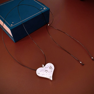 Hammered heart pendant necklace on black adjustable cord inside a premium blue jewelry box