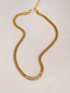 Detailed view of gold-tone wheat chain with baguette-cut stones and lobster clasp closure
