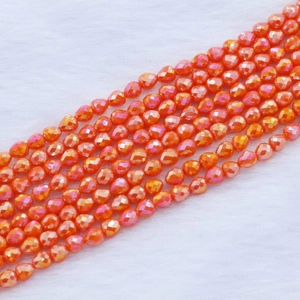 Macro detail of orange strawberry drop beads with iridescent AB coating on fur