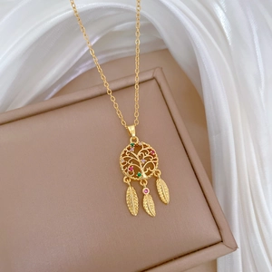Luxurious gold dreamcatcher necklace with colorful crystals and three feather pendants